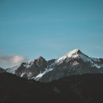 Stunning view of snow-capped mountains against a blue sky, perfect for nature lovers.